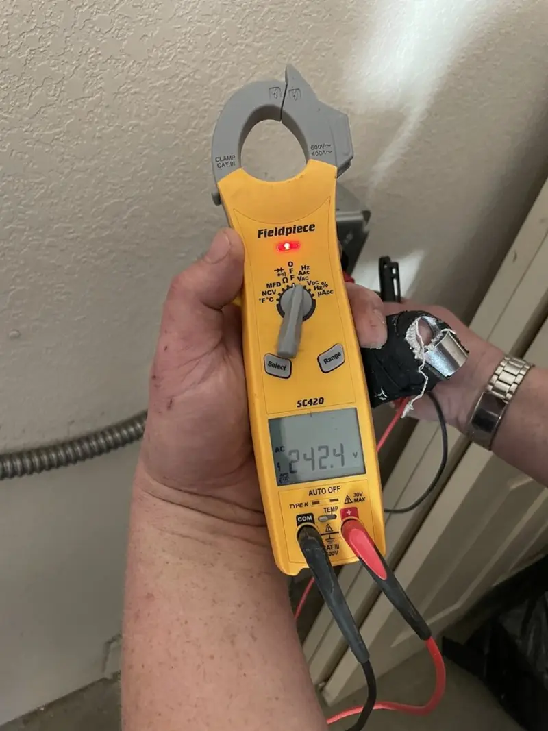 Voltage testing with clamp meter during Whole House Surge Protector in Enochville